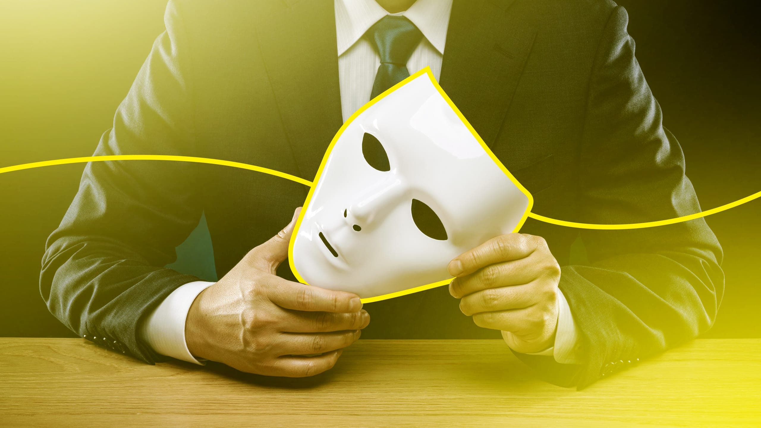 Hands holding an anonymous white mask, with a yellow illustrated line outlining it.